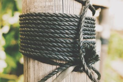 Close-up of rope tied on wooden post