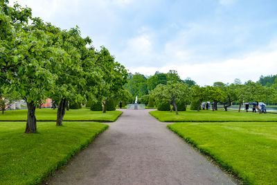 Footpath in park against sky