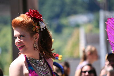 Happy beautiful woman looking away during gay parade