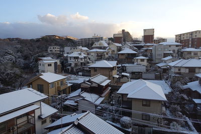 High angle view of buildings in town against sky