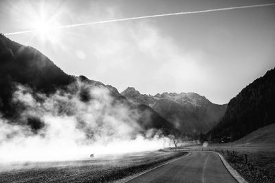 Road amidst mountains against sky