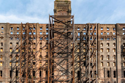 Low angle view of construction site against sky