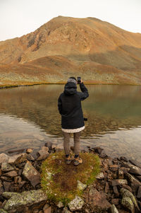 Rear view of man standing on rock