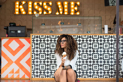 Young woman eating ice cream outdoors