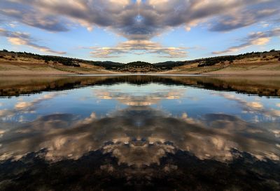 Scenic view of lake against cloudy sky