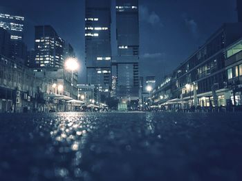 Illuminated cityscape against sky at night