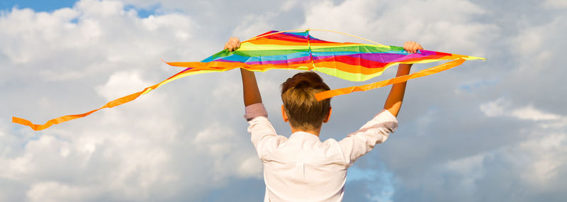 Portrait of a child 8-9 years old with a kite. a blond boy stands and looks into the distance 