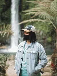 Man wearing hat while standing on land