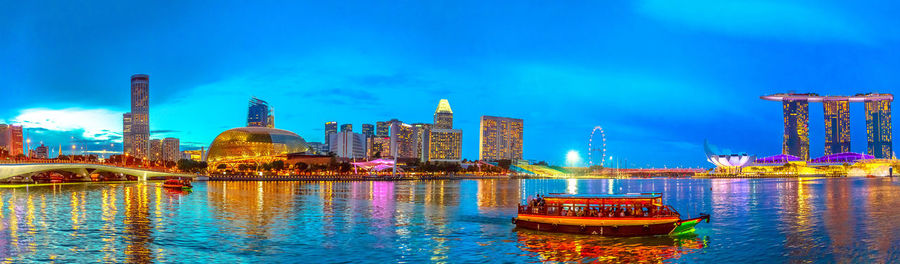 Illuminated buildings in city at waterfront