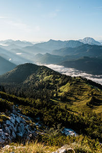 Scenic view of tegernsee valley during sunrise from roßstein mountain peak.