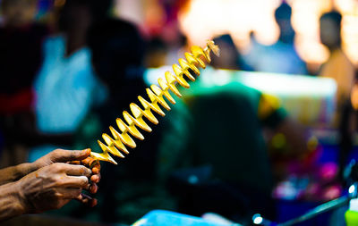 Cropped hand of woman holding food