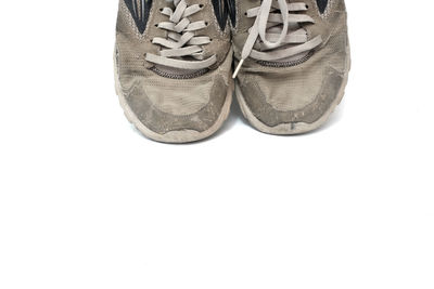 Low section of shoes against white background