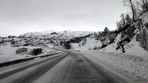 Empty road with mountains in background