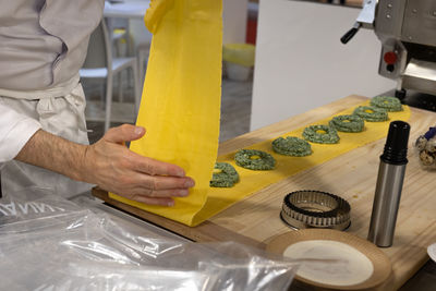 Midsection of man working on table