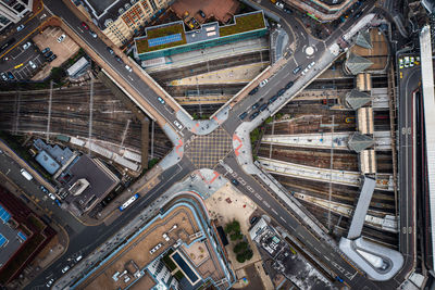 Aerial view directly above a complex city street junction and railway tracks