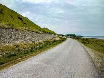 Road by sea against sky