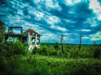 Abandoned built structure on field against sky