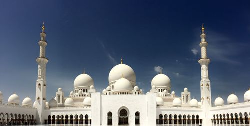 Low angle view of mosque against blue sky