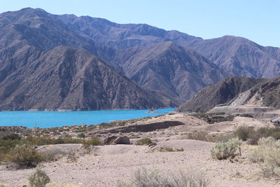 Scenic view of sea and mountains against sky