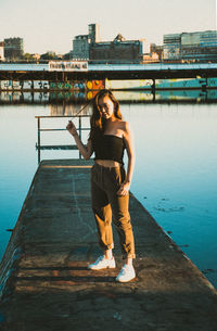 Full length of woman standing on pier