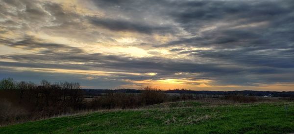 Scenic view of field against sky during sunset