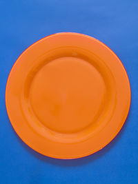 High angle view of orange juice against blue background