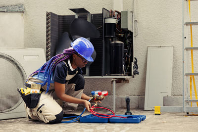 Side view of man working at construction site