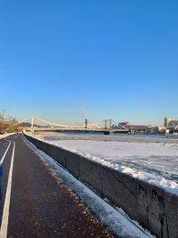 Road against clear sky during winter