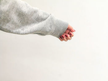 Close-up low section of man over white background