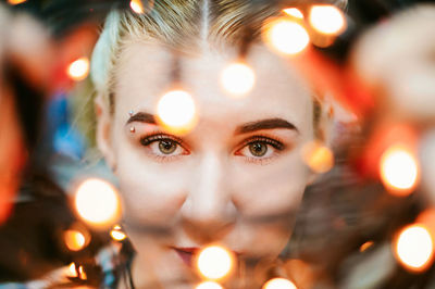 Close-up portrait of illuminated girl