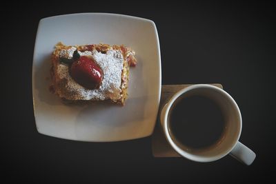 Dessert in plate against black background