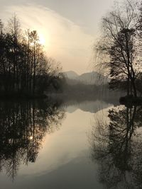 Scenic view of lake against sky at sunset