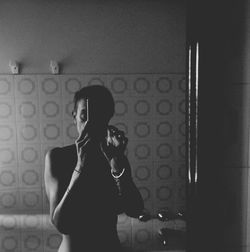 Full length of woman photographing through smart phone