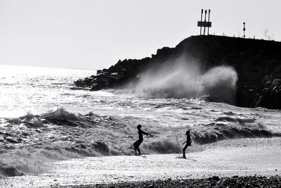 Full length of man on beach against clear sky