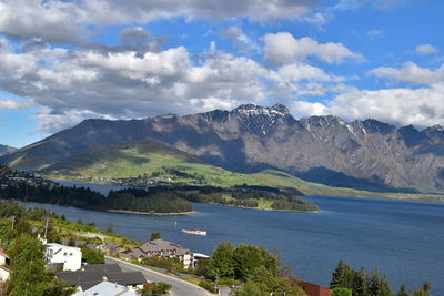 Scenic view of sea and mountains against sky