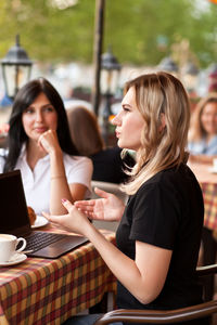 Women sitting on table in restaurant