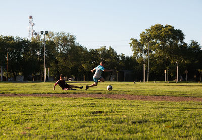 Children playing soccer outdoors