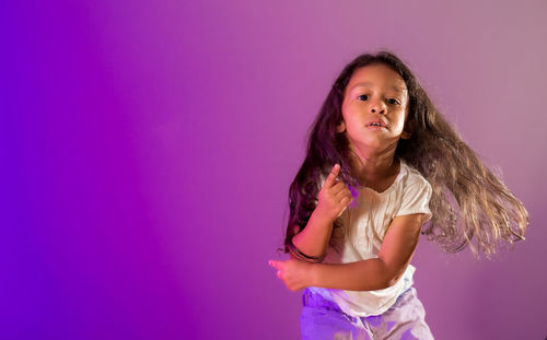 Portrait of a girl against pink background