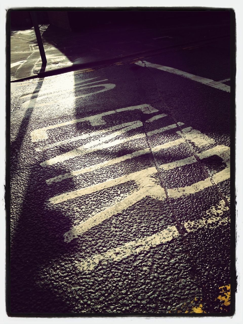 transfer print, auto post production filter, high angle view, street, shadow, sunlight, low section, sidewalk, road marking, road, text, day, outdoors, pattern, close-up, communication, empty, western script, asphalt