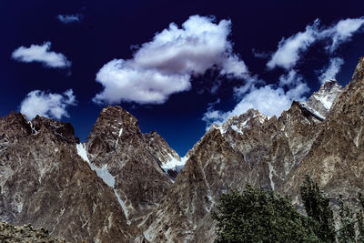 Low angle view of snowcapped mountains against sky