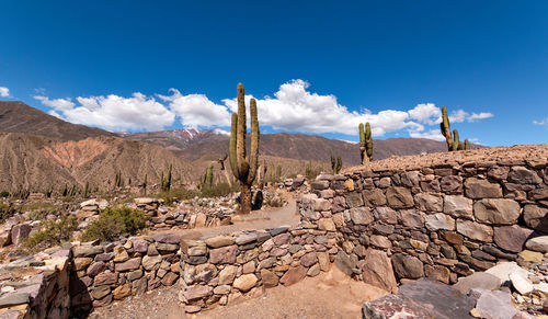 Scenic view of rocks against blue sky