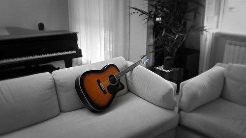 Guitar on bed at home