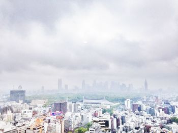 Cityscape against cloudy sky