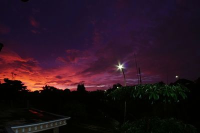 Silhouette trees against sky at sunset