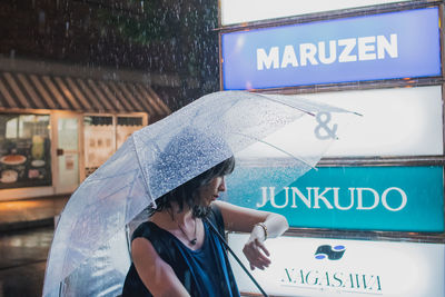 Woman standing on information sign