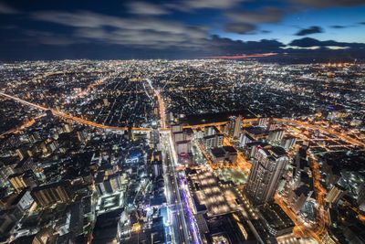 Aerial view of city lit up at night