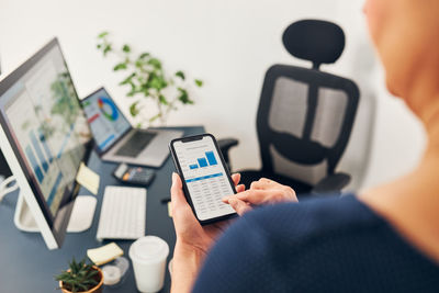 Midsection of woman using mobile phone