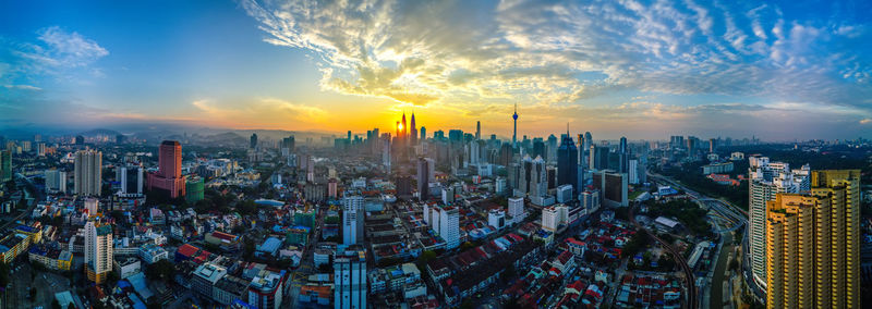 The sun rises between two buildings at kuala lumpur, malaysia