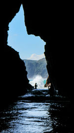 Scenic view of sea seen through cave