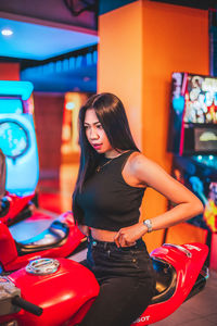 Portrait of young woman sitting on the motorbike acarde 